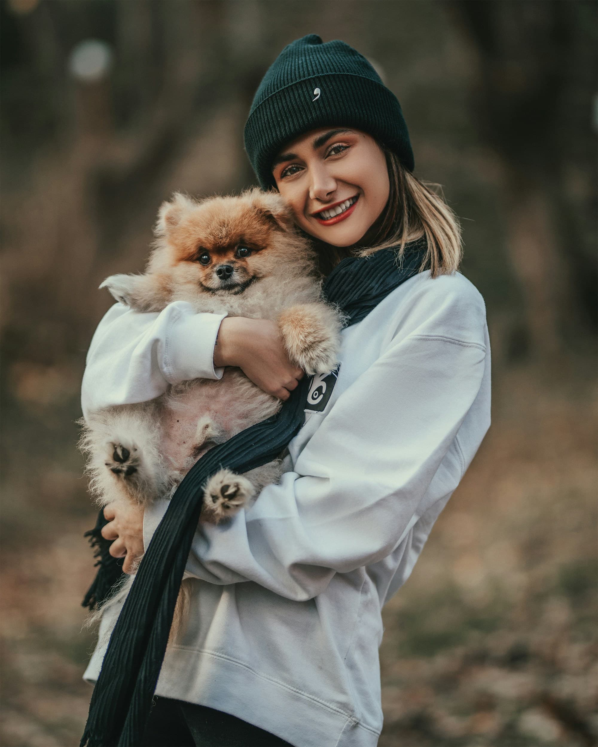 Sarah M. smiling with her Teacup Poodle Bella
